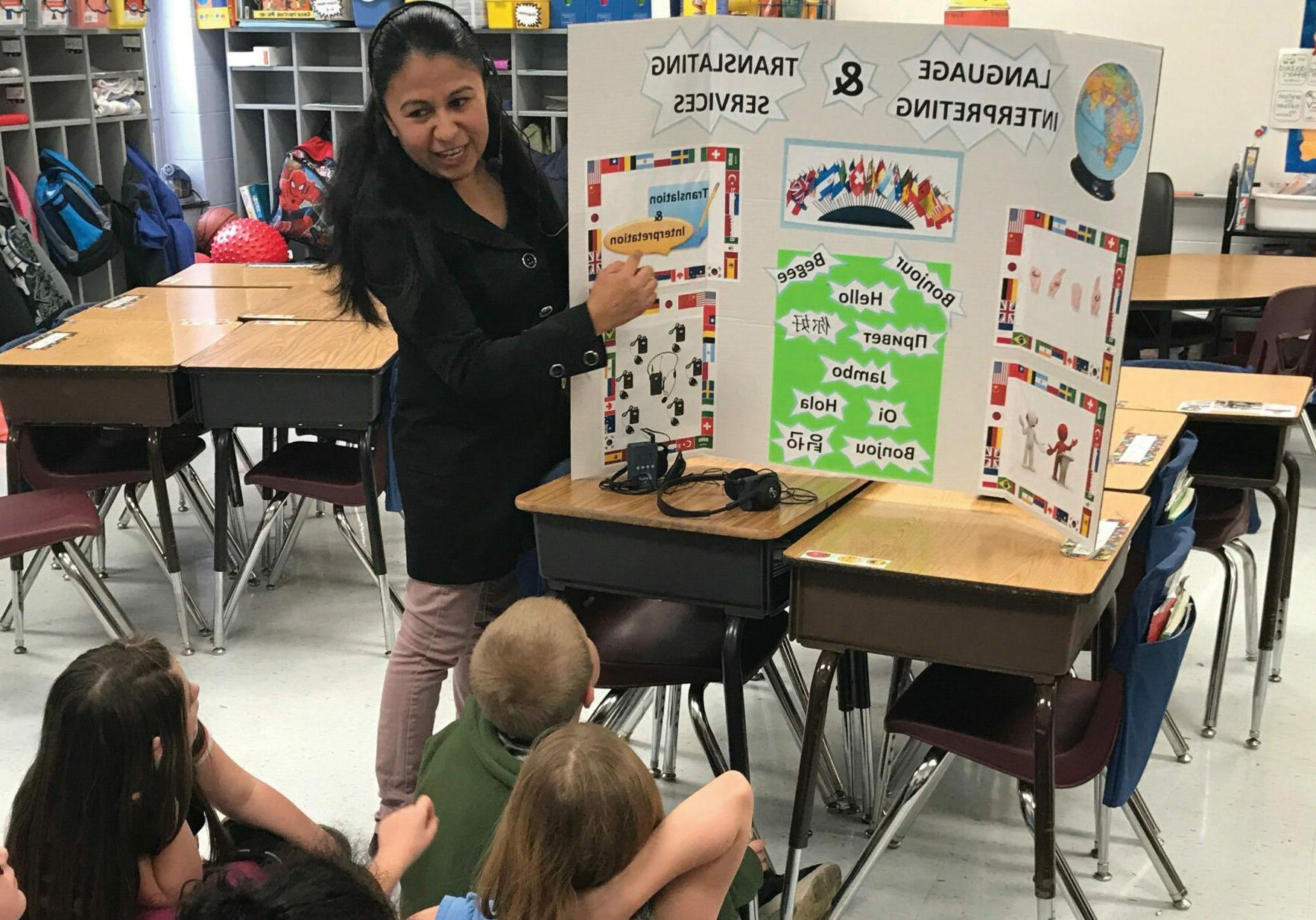 Jessica Sanchez explains the difference between translation and interpreting to students at Harrison Elementary School’s Career Day in Lexington, Kentucky.
